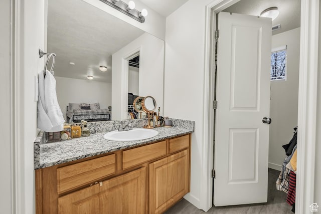 5116 W Rock Butte Rd, Herriman, UT 84096 - bathroom featuring baseboards, visible vents, and vanity