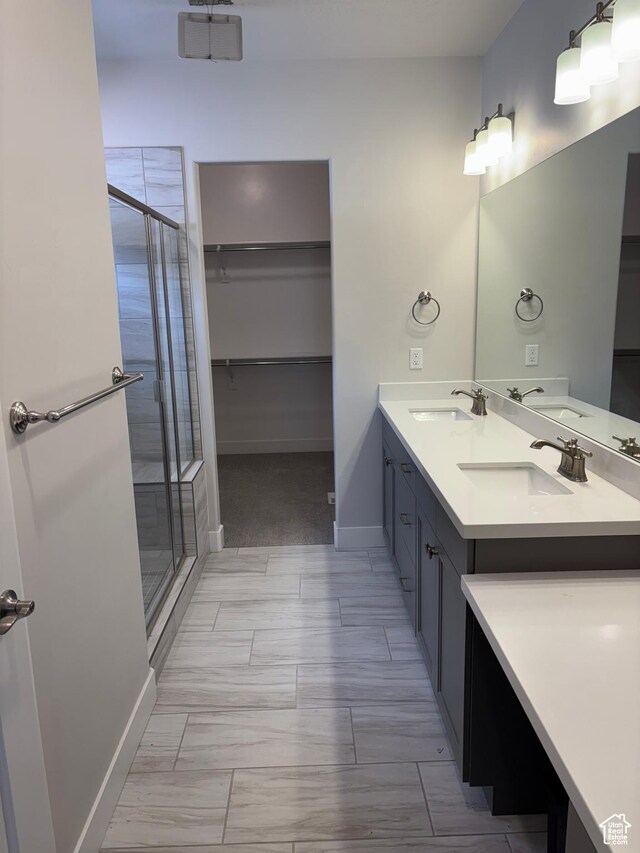 12038 S Middle Teton Dr Unit 134, Herriman, UT 84096 - full bath with a shower stall, double vanity, a spacious closet, and baseboards