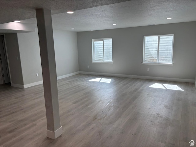 12038 S Middle Teton Dr Unit 134, Herriman, UT 84096 - unfurnished room featuring wood finished floors, baseboards, a textured ceiling, and recessed lighting