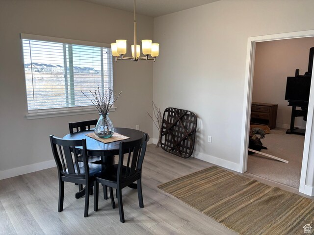 12038 S Middle Teton Dr Unit 134, Herriman, UT 84096 - dining room with a chandelier, wood finished floors, and baseboards