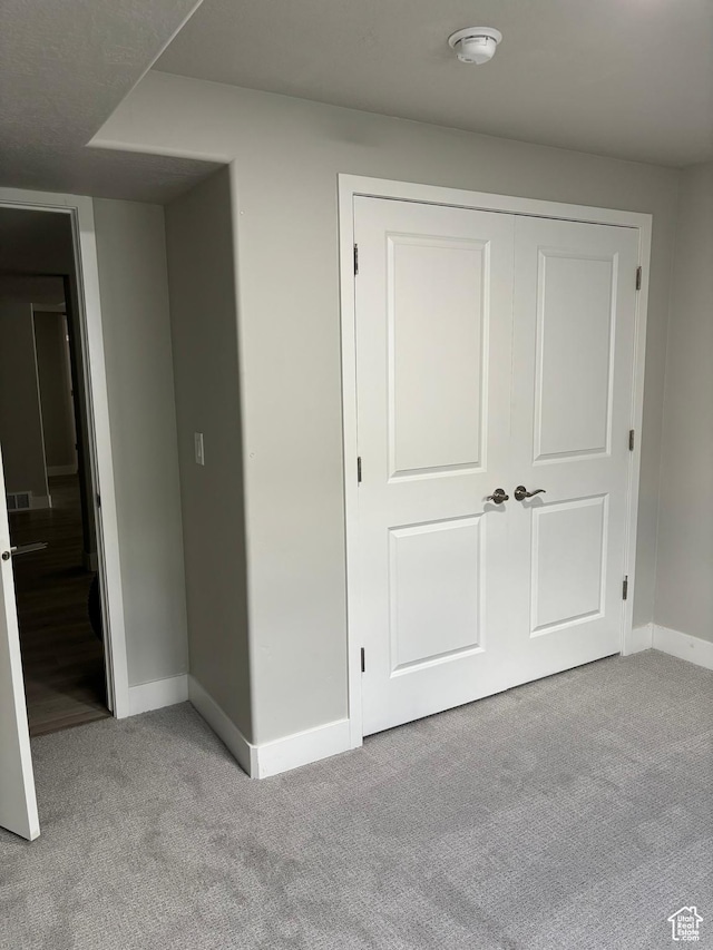 12038 S Middle Teton Dr Unit 134, Herriman, UT 84096 - unfurnished bedroom with carpet floors, baseboards, and a closet