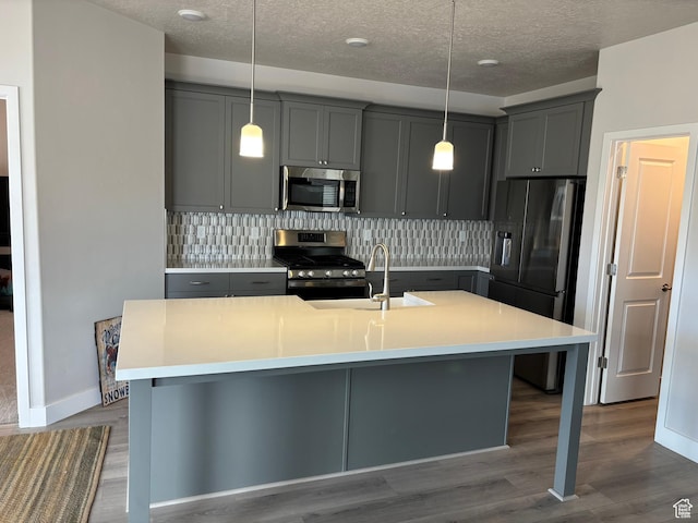 12038 S Middle Teton Dr Unit 134, Herriman, UT 84096 - kitchen with appliances with stainless steel finishes, gray cabinetry, decorative backsplash, a textured ceiling, and light countertops
