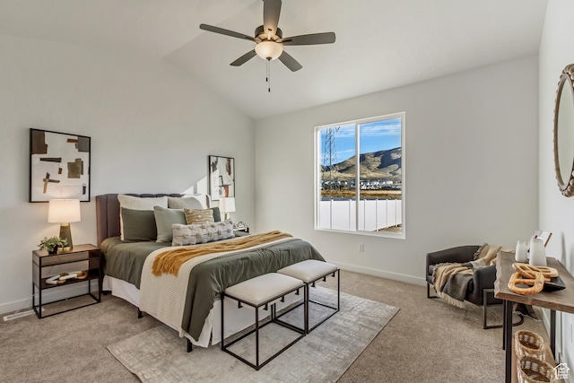 bedroom with baseboards, lofted ceiling, light colored carpet, and ceiling fan