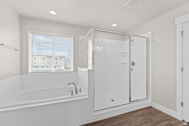full bath with a garden tub, visible vents, wood finished floors, recessed lighting, and a shower stall