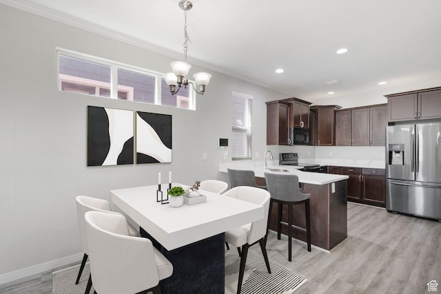 4988 W Currant Dr, South Jordan, UT 84009 - dining space with crown molding, a chandelier, light wood finished floors, recessed lighting, and baseboards