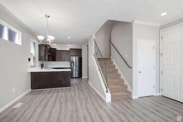4988 W Currant Dr, South Jordan, UT 84009 - kitchen with stainless steel refrigerator with ice dispenser, a sink, dark brown cabinets, a chandelier, and light countertops