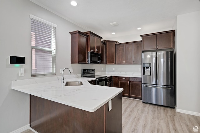 4988 W Currant Dr, South Jordan, UT 84009 - kitchen with black appliances, a sink, dark brown cabinetry, light wood-style floors, and light stone counters