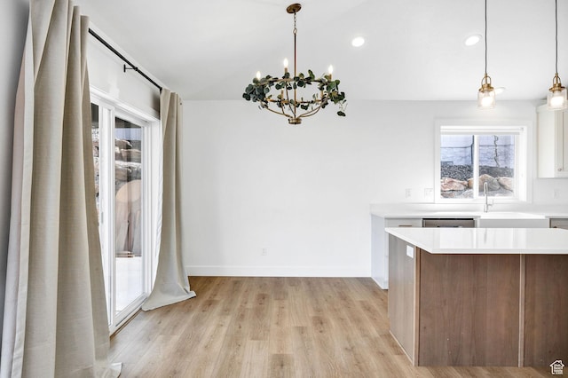 2023 E Mountain View Ln N, Logan, UT 84341 - kitchen with a notable chandelier, light countertops, hanging light fixtures, light wood-type flooring, and white cabinets