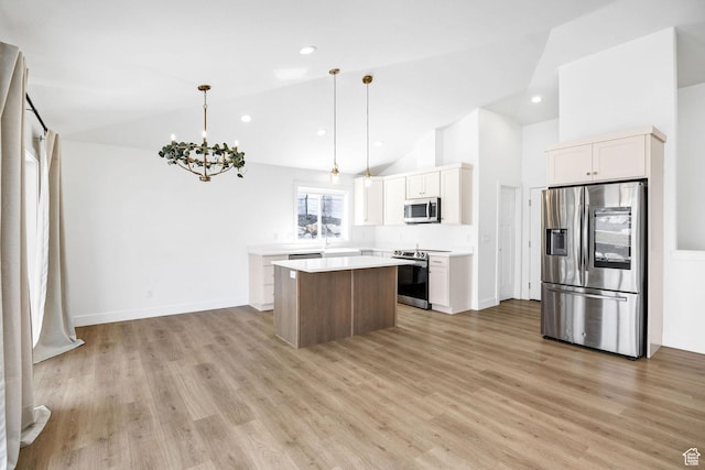 2023 E Mountain View Ln N, Logan, UT 84341 - kitchen with light countertops, stainless steel appliances, a kitchen island, light wood-type flooring, and a notable chandelier