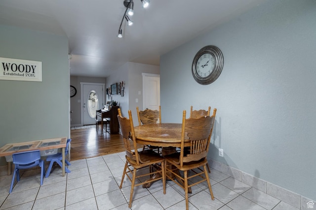 dining room with light tile patterned floors and baseboards