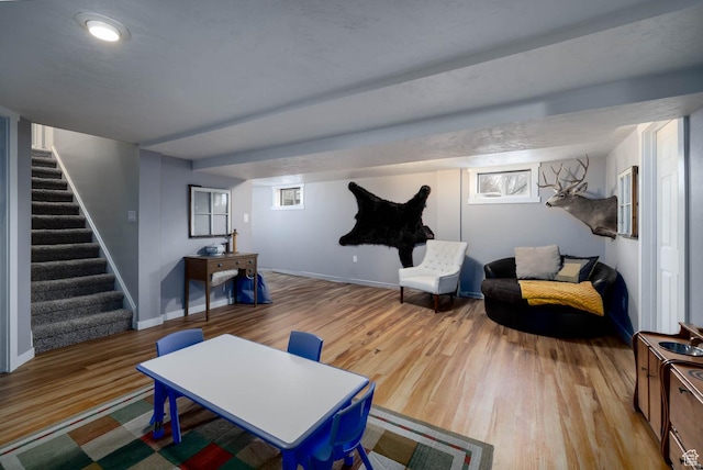 interior space with baseboards, stairs, and wood finished floors