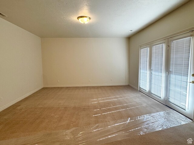 362 S Glen Cir, Fruit Heights, UT 84037 - unfurnished room with visible vents, light carpet, baseboards, and a textured ceiling