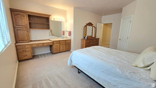 362 S Glen Cir, Fruit Heights, UT 84037 - bedroom with built in desk, light colored carpet, baseboards, a sink, and ensuite bathroom