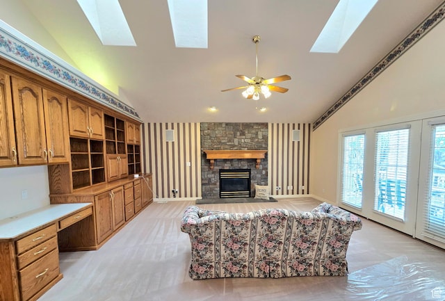 362 S Glen Cir, Fruit Heights, UT 84037 - living room with high vaulted ceiling, a ceiling fan, a skylight, a stone fireplace, and baseboards