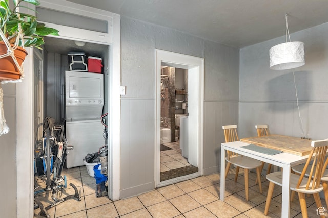 629 S 400 E, Salt Lake City, UT 84111 - dining space featuring wainscoting, light tile patterned flooring, a textured wall, and stacked washer / drying machine