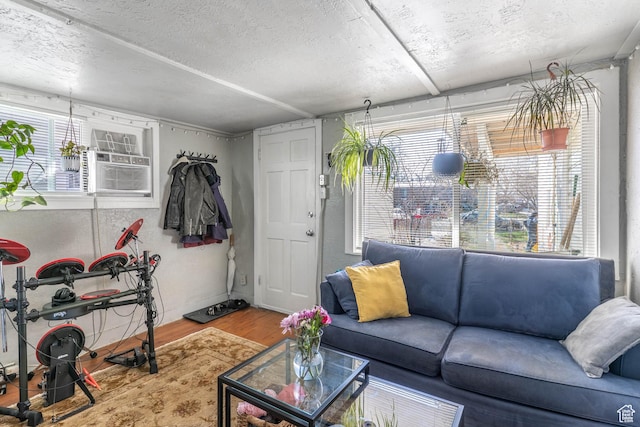 629 S 400 E, Salt Lake City, UT 84111 - living room with cooling unit, a textured ceiling, wood finished floors, and a healthy amount of sunlight