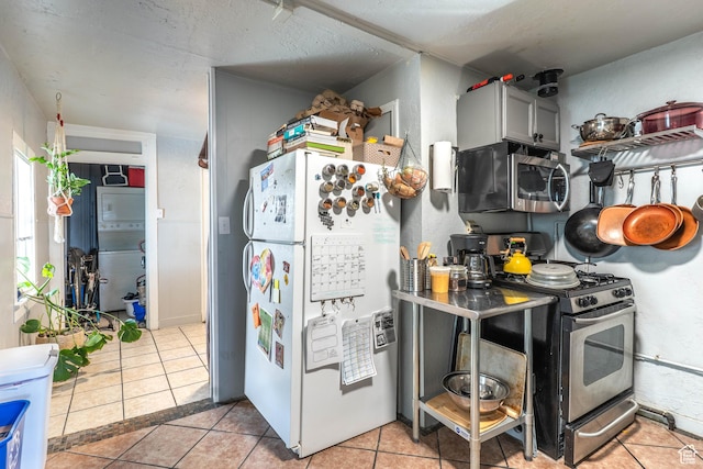 629 S 400 E, Salt Lake City, UT 84111 - kitchen featuring gray cabinets, light tile patterned floors, a textured ceiling, washer / clothes dryer, and appliances with stainless steel finishes