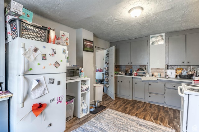 629 S 400 E, Salt Lake City, UT 84111 - kitchen with light countertops, white appliances, gray cabinets, dark wood-type flooring, and a textured ceiling