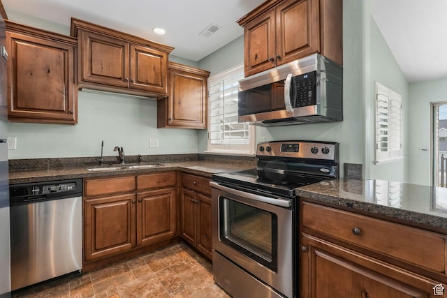 2522 W 500 S Unit 7, Springville, UT 84663 - kitchen featuring a sink, appliances with stainless steel finishes, brown cabinets, visible vents, and dark stone counters