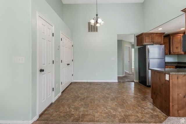 2522 W 500 S Unit 7, Springville, UT 84663 - kitchen featuring visible vents, a chandelier, baseboards, brown cabinetry, and freestanding refrigerator