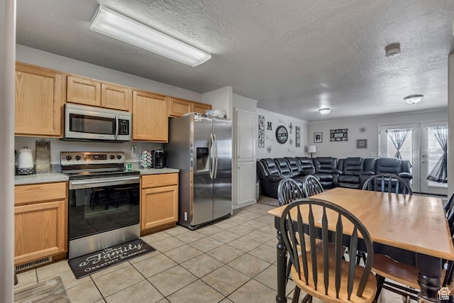 333 S Monroe Blvd Unit 23, Ogden, UT 84404 - kitchen featuring open floor plan, light countertops, light brown cabinetry, and stainless steel appliances