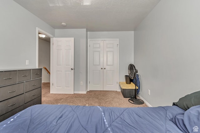 333 S Monroe Blvd Unit 23, Ogden, UT 84404 - carpeted bedroom with baseboards, a closet, and a textured ceiling