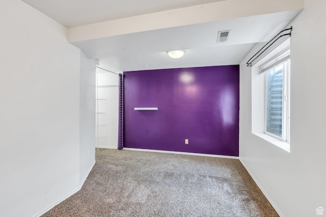 carpeted empty room with baseboards and visible vents