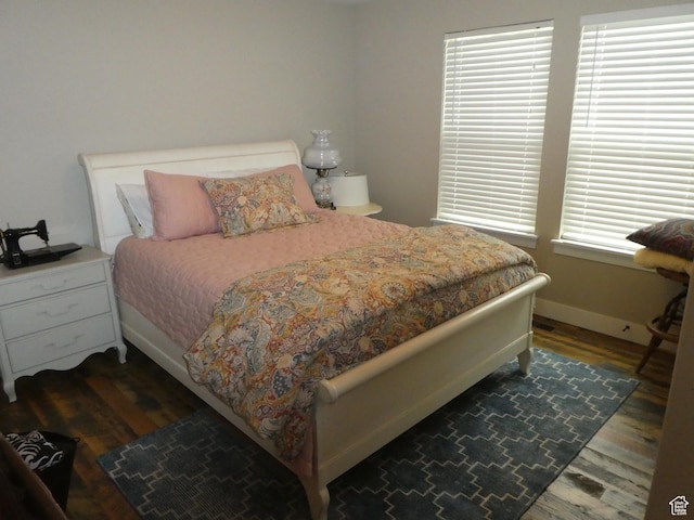 bedroom featuring baseboards and wood finished floors