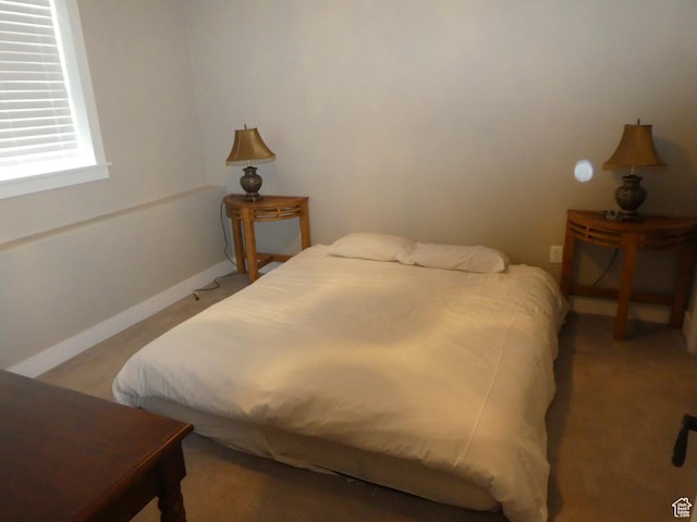 carpeted bedroom with baseboards