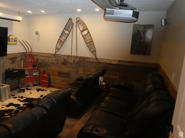 cinema room with a wainscoted wall, wood walls, and recessed lighting