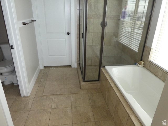 bathroom with a shower stall, tile patterned floors, toilet, and a bath