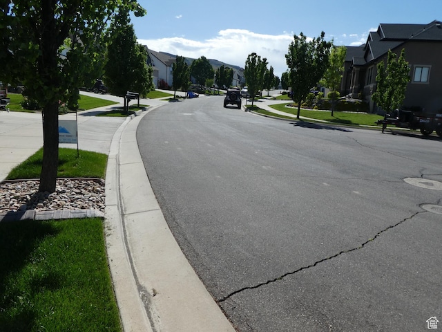 4613 W Brookport Cir S Unit V3-8, Herriman, UT 84096 - view of asphalt street with a residential view, curbs, and sidewalks