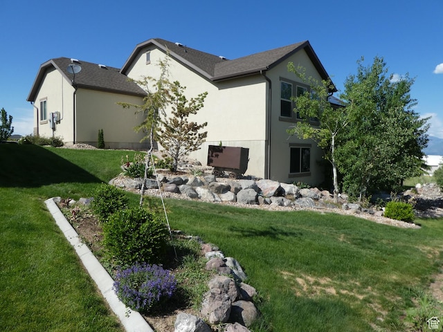 4613 W Brookport Cir S Unit V3-8, Herriman, UT 84096 - view of home's exterior with stucco siding and a lawn