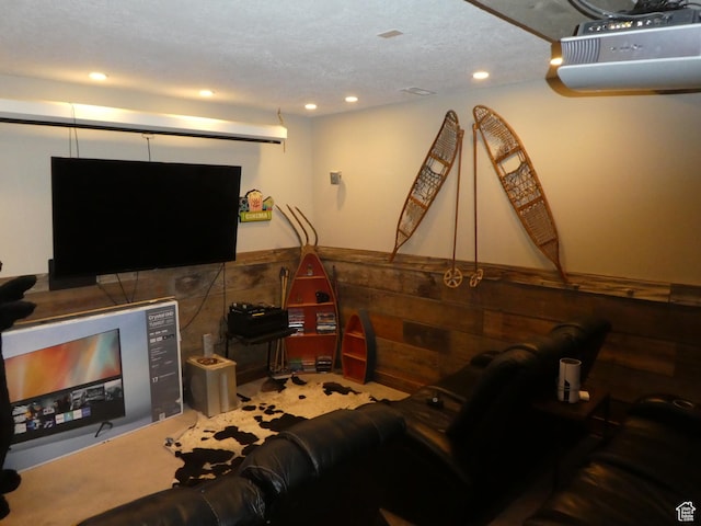 game room with wainscoting, wood walls, recessed lighting, and a textured ceiling