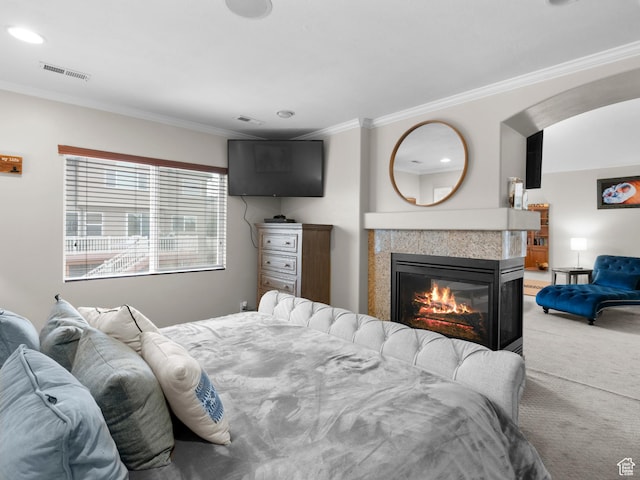 14526 Long Ridge Dr, Herriman, UT 84096 - bedroom featuring light colored carpet, recessed lighting, ornamental molding, visible vents, and a glass covered fireplace