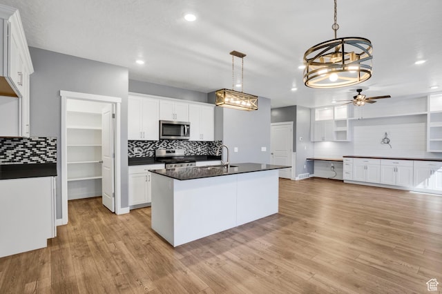 900 E Mecham Ave, Layton, UT 84040 - kitchen with ceiling fan with notable chandelier, a sink, dark countertops, and appliances with stainless steel finishes