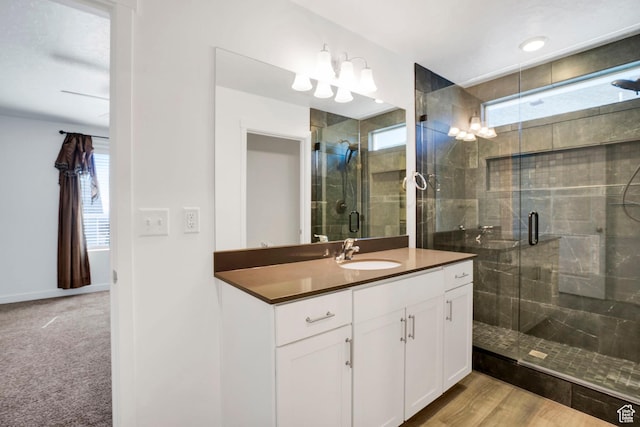 900 E Mecham Ave, Layton, UT 84040 - bathroom featuring a stall shower, baseboards, and vanity