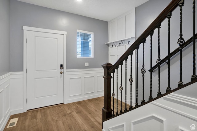 900 E Mecham Ave, Layton, UT 84040 - entryway with stairs, light wood-style flooring, visible vents, and a wainscoted wall