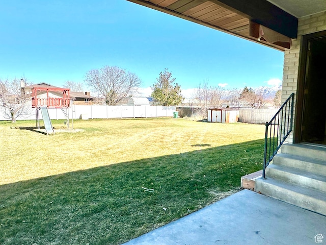 2662 W Toni Lee St, West Jordan, UT 84088 - view of yard with an outdoor structure, a fenced backyard, and a shed