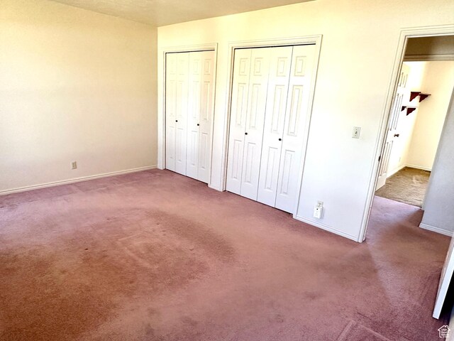 2662 W Toni Lee St, West Jordan, UT 84088 - unfurnished bedroom featuring carpet flooring, baseboards, and two closets