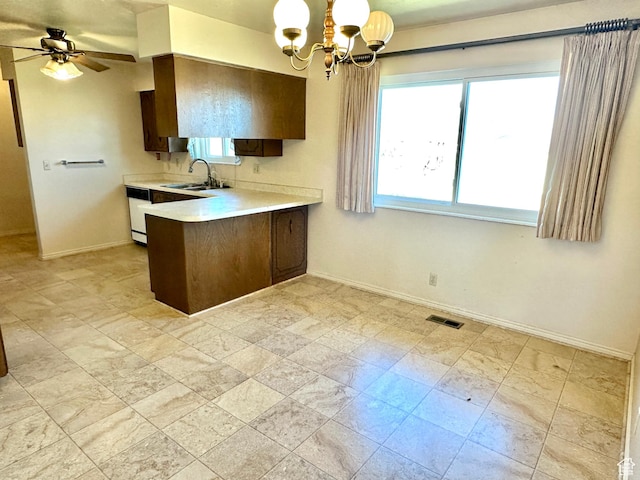 2662 W Toni Lee St, West Jordan, UT 84088 - kitchen with light countertops, visible vents, a peninsula, a sink, and ceiling fan with notable chandelier