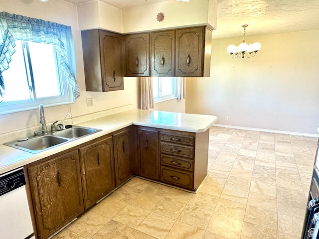2662 W Toni Lee St, West Jordan, UT 84088 - kitchen featuring light countertops, a sink, dishwasher, a peninsula, and a notable chandelier
