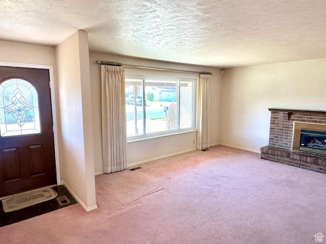 2662 W Toni Lee St, West Jordan, UT 84088 - foyer with carpet flooring, baseboards, a textured ceiling, visible vents, and a fireplace