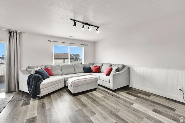 198 S 1130 E, Hyrum, UT 84319 - living area with a wainscoted wall, wood finished floors, track lighting, and a textured ceiling