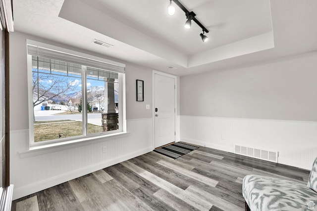 198 S 1130 E, Hyrum, UT 84319 - entryway featuring a wainscoted wall, visible vents, wood finished floors, and a raised ceiling