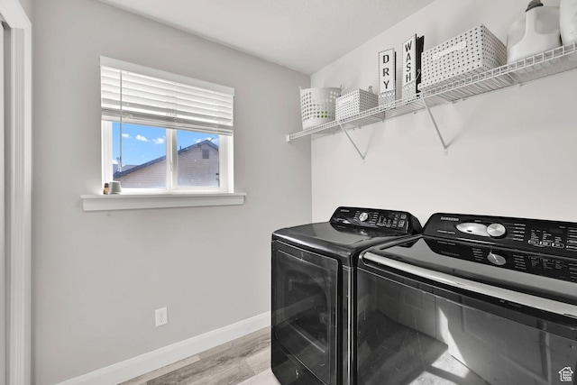 198 S 1130 E, Hyrum, UT 84319 - washroom featuring washing machine and clothes dryer, light wood-style flooring, baseboards, and laundry area