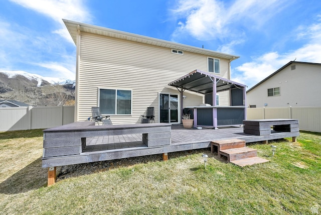 198 S 1130 E, Hyrum, UT 84319 - back of property featuring a hot tub, a fenced backyard, a deck with mountain view, a pergola, and a yard
