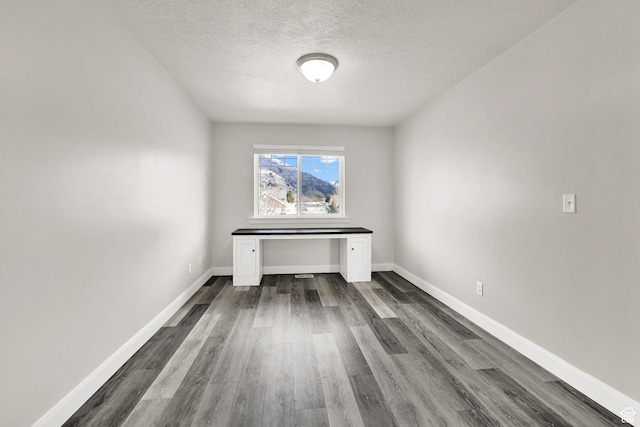 198 S 1130 E, Hyrum, UT 84319 - unfurnished room with dark wood-style floors, baseboards, and a textured ceiling