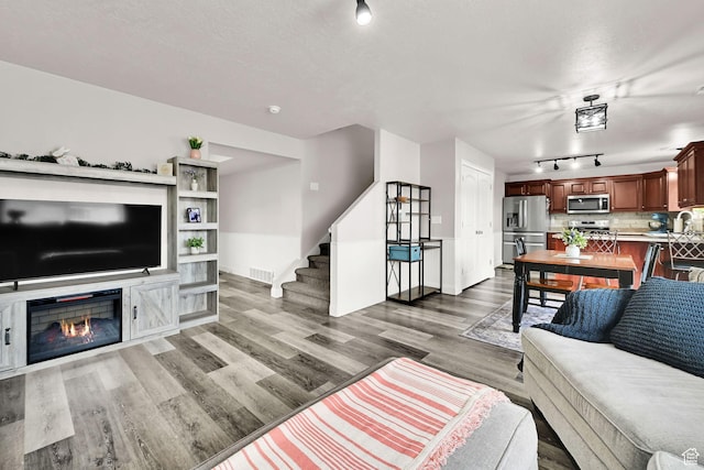 198 S 1130 E, Hyrum, UT 84319 - living area with stairs, visible vents, wood finished floors, and a textured ceiling