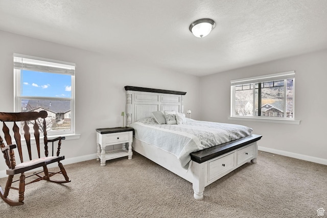 198 S 1130 E, Hyrum, UT 84319 - bedroom with baseboards, multiple windows, light colored carpet, and a textured ceiling